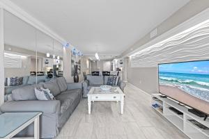 a living room with a couch and a large screen tv at 317 - Fantastic 3 BR Oceanfront Corner in Edgewater