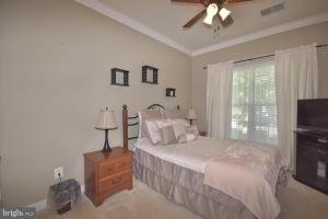 a bedroom with a bed and a ceiling fan at Ormond in Bristow