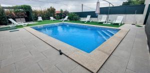 a small swimming pool with chairs at Varandas do Dão & Estrela in Pardieiros