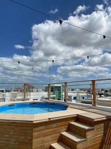 a swimming pool on the roof of a building at 3bed Apartment con Terraza y Picsina privada in Santo Domingo