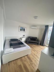 a bedroom with a bed and a living room at Sophies Apartment in Stuttgart