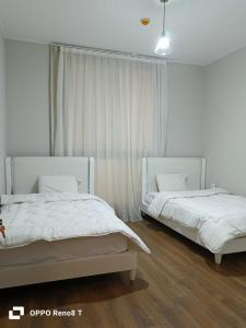 two beds sitting next to each other in a bedroom at luxury apartment three bedrooms three bathrooms in 6th Of October +23 photos