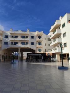a large apartment building with a plaza in front of it at Dunas do Alvor by MyLokals in Alvor