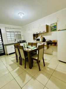 a kitchen with a table and chairs and a refrigerator at L'Aquolina in Socorro