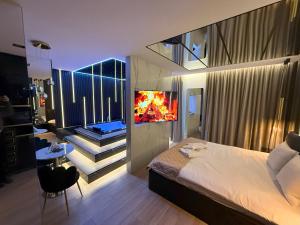 a bedroom with a bed and a balcony with a fireplace at Wiślane Tarasy 2 VIP Apartamenty JACUZZI in Krakow