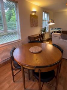a living room with a wooden table and chairs at Wheel Corner Cottage in Kingsteignton