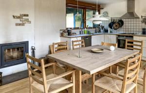 a kitchen with a wooden table and chairs at 4 Bedroom Beautiful Home In Vejby in Vejby