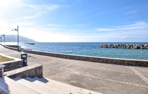 einen Gehweg am Meer mit einer Felswand in der Unterkunft Amazing Apartment In Santa Maria Di Castell in Santa Maria di Castellabate + 13 Fotos