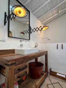 a bathroom with a sink and a mirror at Casa da Oliveira - Bordeira in Bordeira