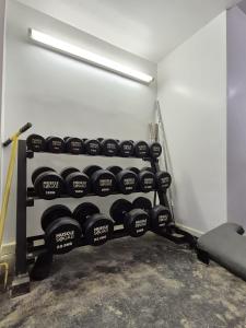 a gym with a rack of dumbbells in a room at Grand Vintage Home with Sauna & Style in Kirby Muxloe