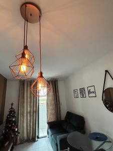a living room with two lights and a christmas tree at Apartamento 104, praias do litoral sul in João Pessoa