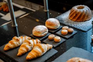 a bunch of croissants and pastries on a table at Hotel Maria Theresia in Mayrhofen