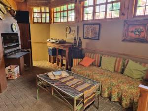 a living room with a couch and a table at Bergsig Self catering in Harrismith