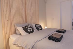 a bed with two pillows on top of it at Arctic City Apartment in Rovaniemi