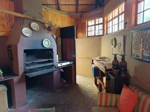 a room with a fireplace and clocks on the wall at Bergsig Self catering in Harrismith +10 photos