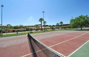 a tennis court with a net on a tennis court at Cozy Apartment In Isola Capo Rizzuto in Isola Capo Rizzuto