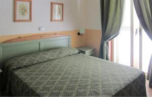 a bedroom with a bed and a large window at Cozy Apartment In Isola Capo Rizzuto in Isola Capo Rizzuto