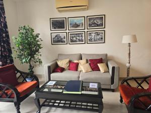 a living room with a couch and a table at Two Green Park in New Delhi