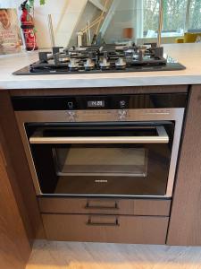 a stove top oven sitting inside of a kitchen at Vakantiewoning Sunclass Durbuy Ardennen huisnummer 68 in Durbuy