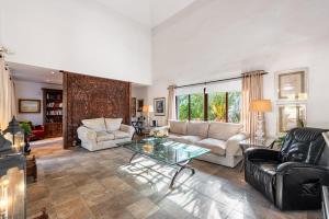 a living room with a couch and a table at Gorgeous Spanish Chalet, Pool and Views in Málaga