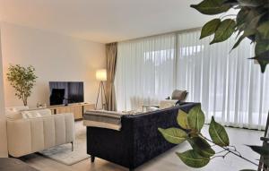 a living room with a couch and a television at Experience luxury in this stunning three-bedroom modern townhouse frontline to the San Roque Golf in San Roque
