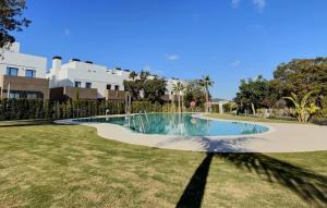 a swimming pool in the middle of a yard at Experience luxury in this stunning three-bedroom modern townhouse frontline to the San Roque Golf in San Roque