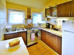a kitchen with a table with a cake on a counter at Holiday Home in Rosnowo by Lake Rosnowskie in Rosnowo