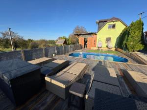 a patio with chairs and a swimming pool at Chata Cerovo in Cerovo