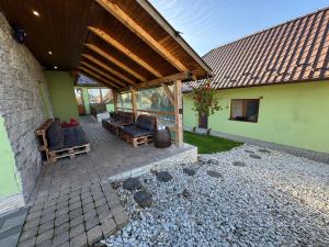 a covered patio with furniture on a house at Chata Cerovo in Cerovo