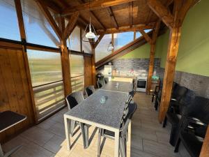 a dining room with a table and chairs at Chata Cerovo in Cerovo