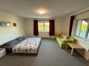 a bedroom with a bed and a couch at Chata Cerovo in Cerovo +25 photos