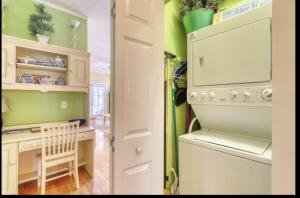 a kitchen with green walls and a washer and dryer at Bay Breeze - 3 Min Walk to Beach in Tybee Island