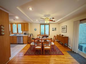 a kitchen and dining room with a table and chairs at Overlook Poolside Getaway With Seasonal Pool in Falmouth