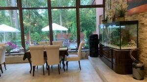 a dining room with a table and a fish tank at Laguna Resort SPA in Augustów