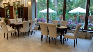 a dining room with a table and chairs at Laguna Resort SPA in Augustów
