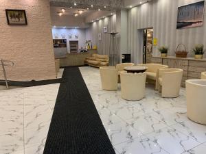 a lobby with white chairs and a table at Laguna Resort SPA in Augustów