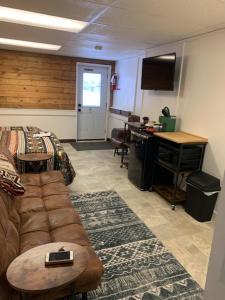 a living room with a couch and a desk at Geraldton Rooms in Geraldton