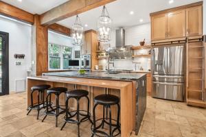a kitchen with a large island with bar stools at Midtown 6bed 5bath w pool and sauna in Atlanta