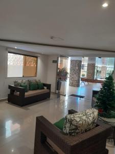 a living room with two couches and a christmas tree at APTO 38- Enseada- Próximo ao Pão de Açúcar in Guarujá