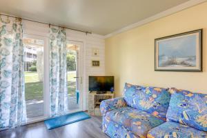a living room with a couch and a tv at Emerald Isle Vacation Rental, Walk to Beach! in Emerald Isle