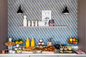 a buffet with bread and other foods on a table at OKKO Hotels Cannes Centre in Cannes