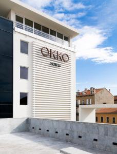 a white building with a sign on it at Okko Hotels Cannes Centre in Cannes