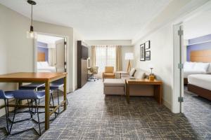 a hotel room with a bed and a desk at Residence Inn Orlando Lake Buena Vista in Orlando +40 photos