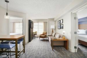 a hotel room with a bed and a living room at Residence Inn Orlando Lake Buena Vista in Orlando