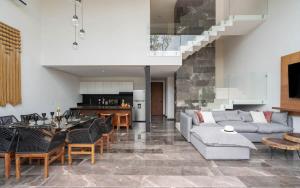 a living room with a couch and a table at Exclusive 4BR Villa in Karanda with Pools and Paddle in Tulum +51 photos