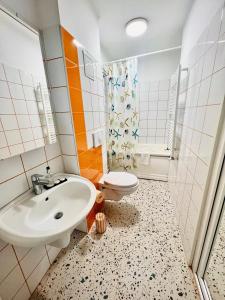 a bathroom with a sink and a toilet at Piata Ovidiu 14 in Constanţa +29 photos
