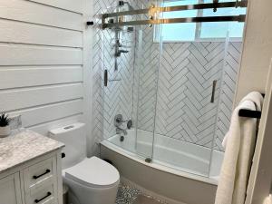 a bathroom with a tub and a toilet and a sink at Contemporary 4BR with Ski Run Views in Park City