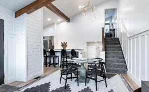 a dining room with a table and chairs and a staircase at Contemporary 4BR with Ski Run Views in Park City +12 photos