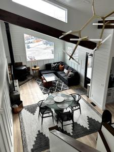 a living room with a table and a couch at Contemporary 4BR with Ski Run Views in Park City