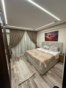 a bedroom with a bed and a painting on the ceiling at Luxury apartment with garden in Janna 2 sheikh Zayed in Sheikh Zayed +19 photos